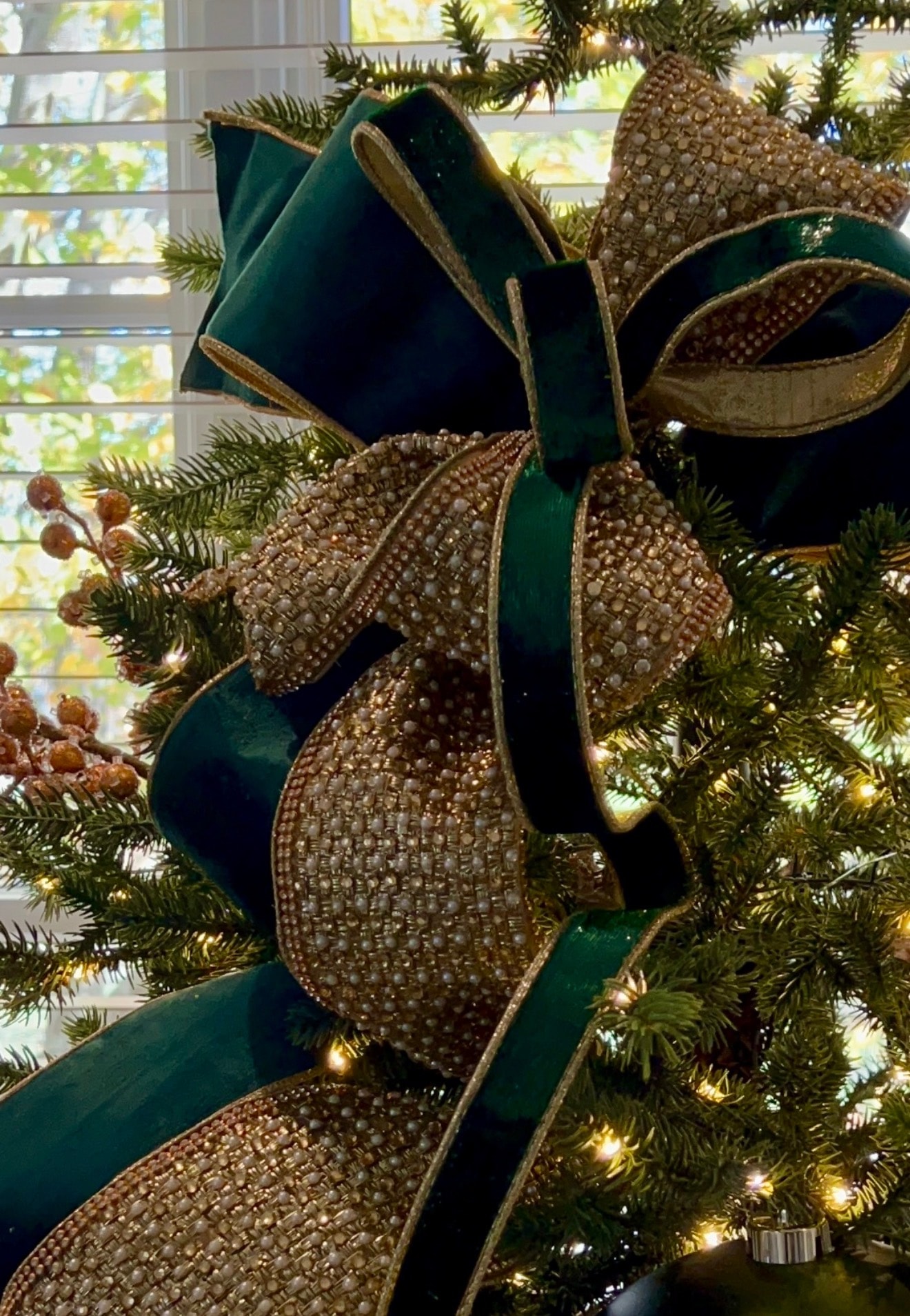 Traditional Christmas tree with large gold north stars — dining room view