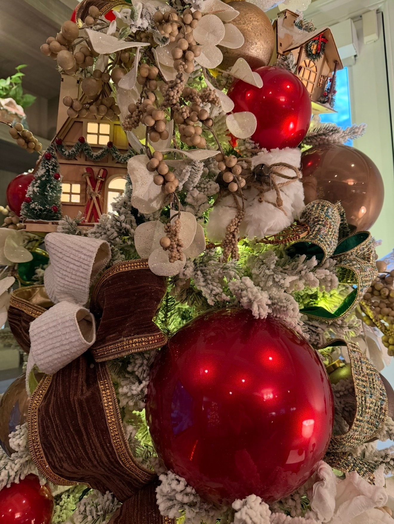 Ski Chalet Christmas tree with cabin ornaments — second angle