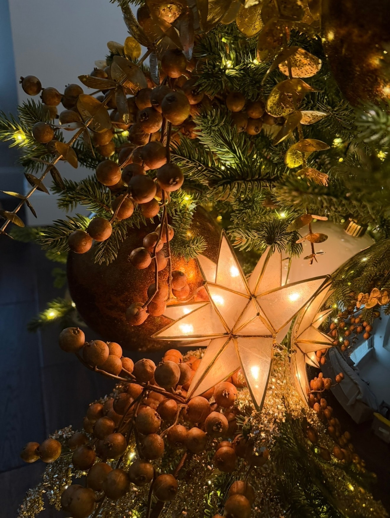 Elegant gold and champagne Christmas tree — star and berry base detail